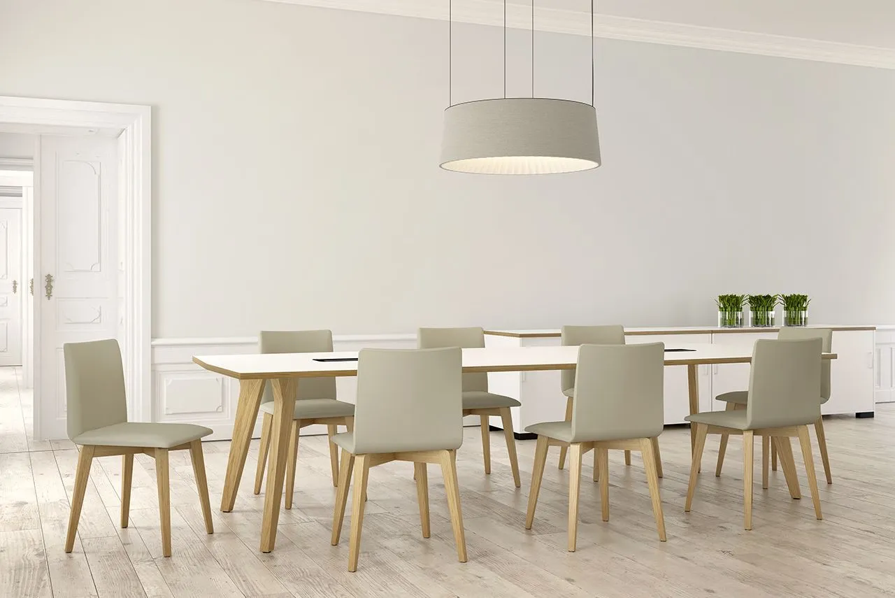 A CGI image of a long wooden table with a white counter top, surrounded by chairs.