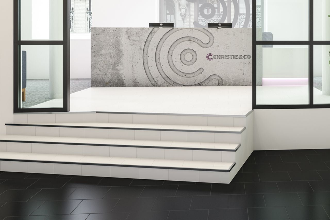 A set of white steps leading to a reception desk.