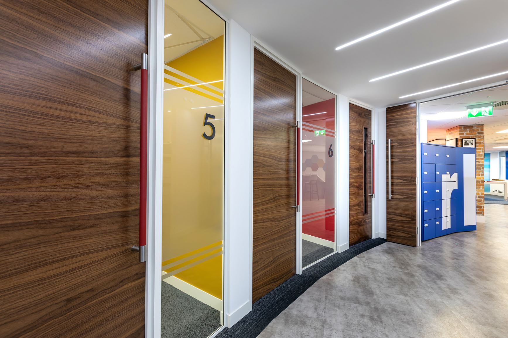 Two meeting rooms with dark wooden doors and glass partitioning.