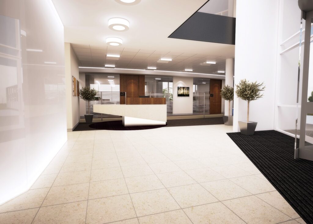 an office reception area with an abstract front desk design and bright spotlighting.