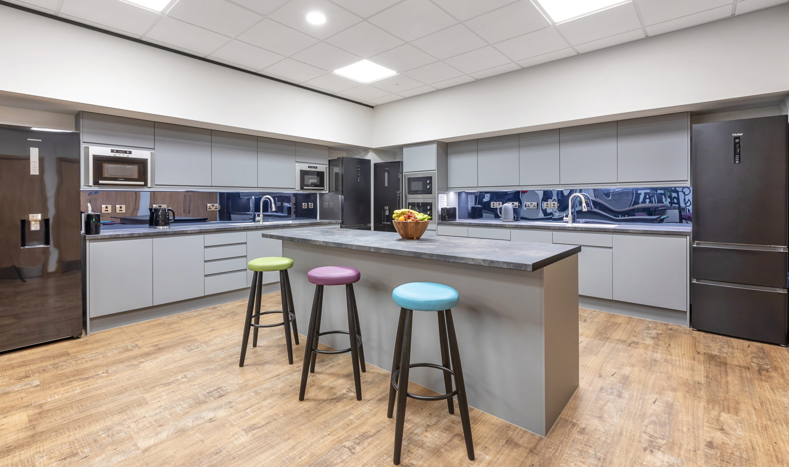 tea point/kitchenette space with colourful high bar stools