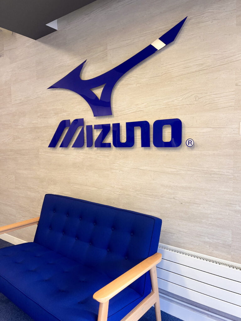 blue mizuno sign in reception with blue sofa underneath 